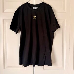 Adidas black tee with gold logo and back zipper detail.